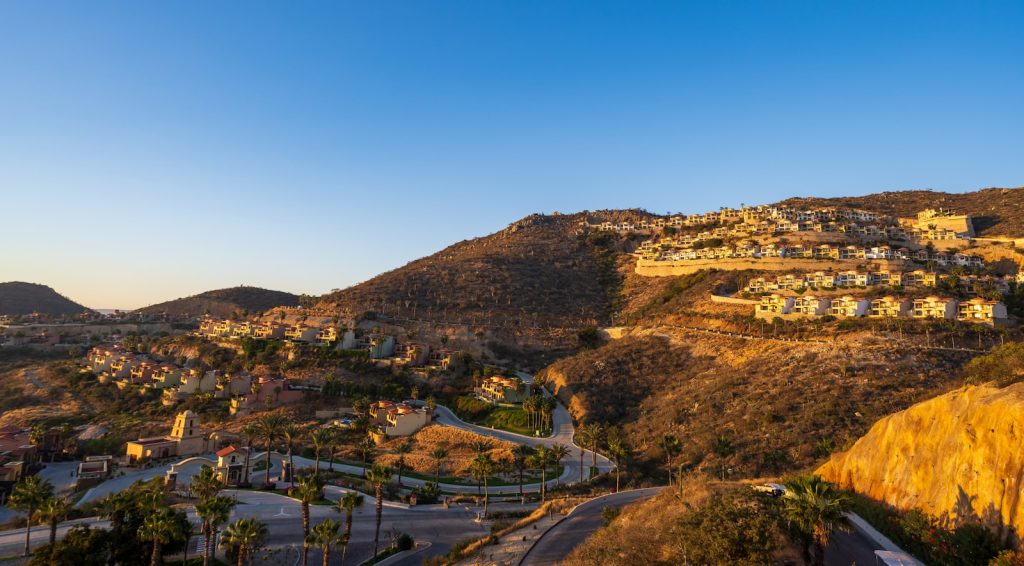 Hillside homes bathed in warm sunset light