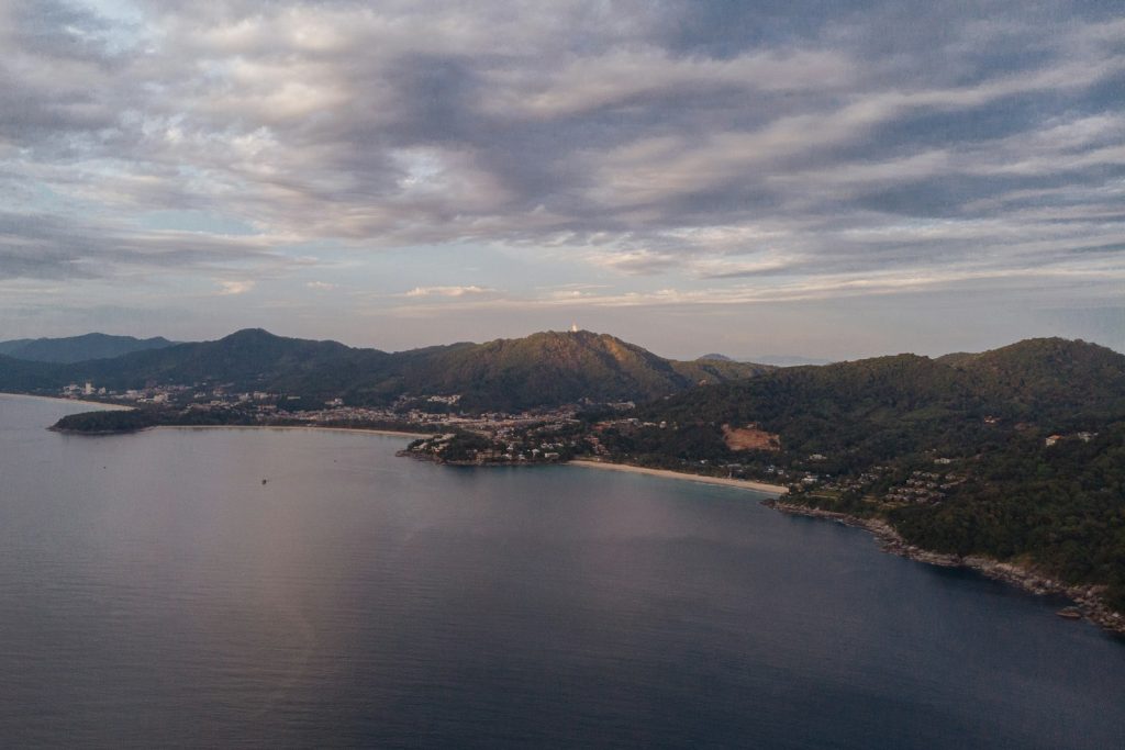 a body of water with hills in the back