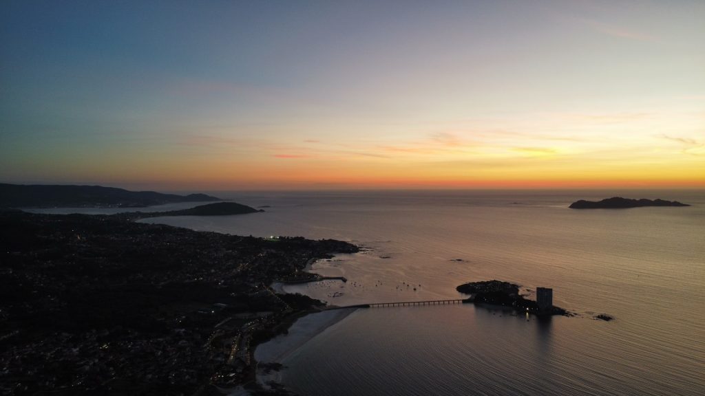 An aerial view of a body of water at sunset