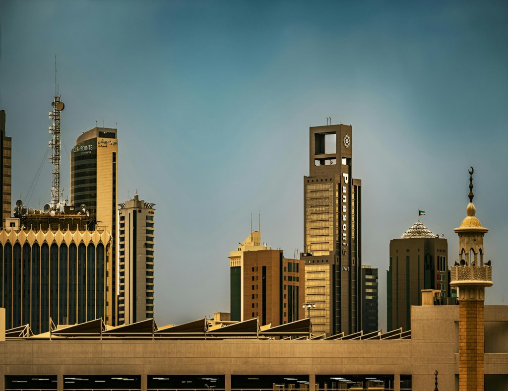 Modern skyscrapers and a minaret under a clear sky